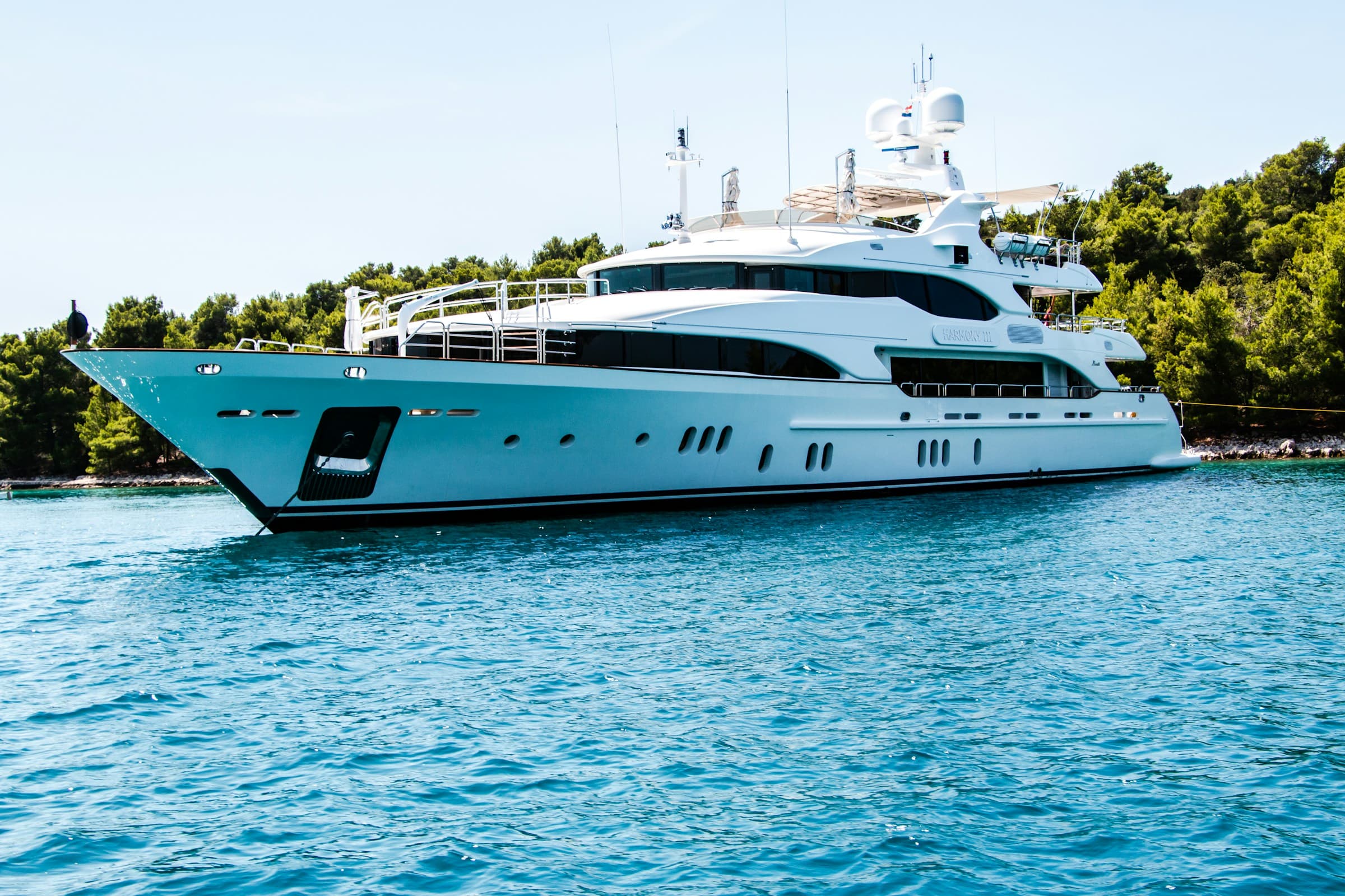 Superyacht at anchor in clear Mediterranean water